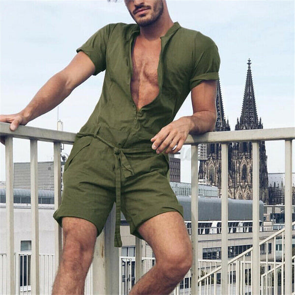 Olive-green short-sleeve romper with a deep V-neck and drawstring waist, modeled on a balcony