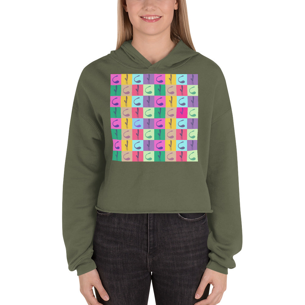 Model wearing an olive cropped hoodie with a colorful repeating vibrator graphic