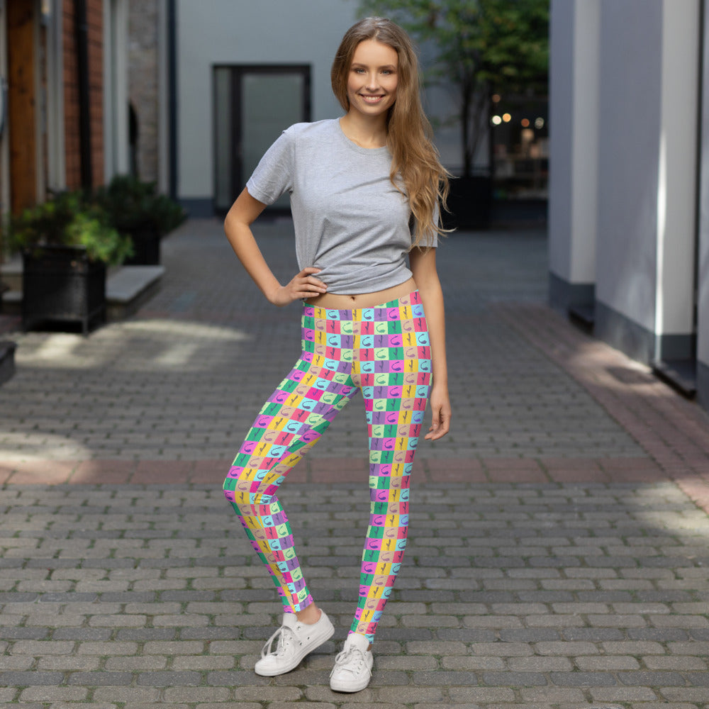 Colorful pop art vibrator-print leggings worn with a gray T-shirt and white sneakers