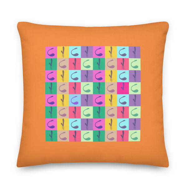 Vibrator Pop Art Pillow with bold rainbow geometrics on a beige sofa; sunlight, art prints, and coffee table with cup and plant.