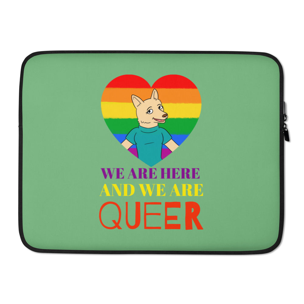 Front view of a green laptop sleeve with a rainbow heart and wolf, reading “WE ARE HERE AND WE ARE QUEER.”