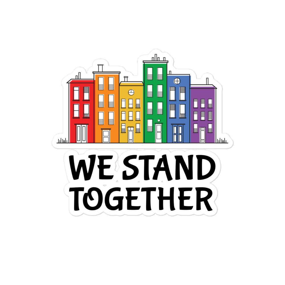 Sticker showing colorful row houses above the words “WE STAND TOGETHER”