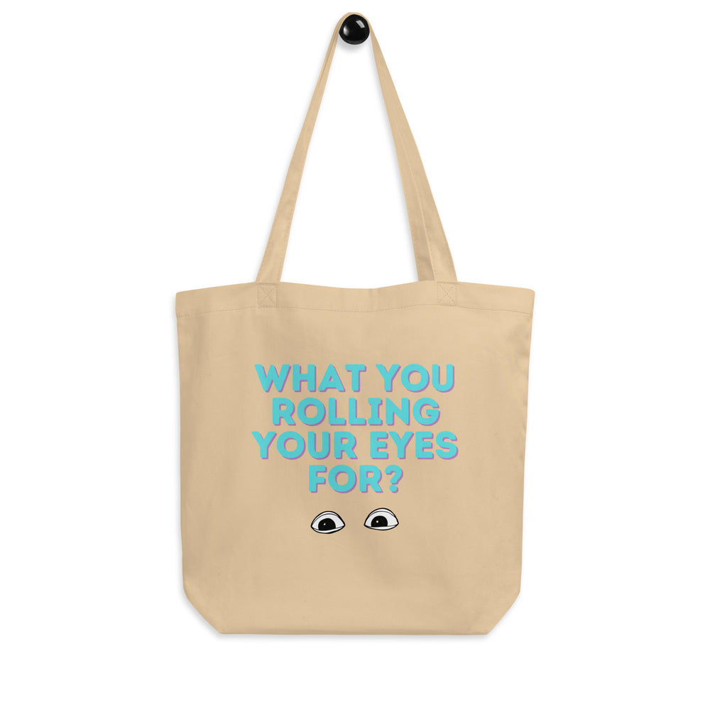 Natural canvas tote bag with turquoise text, “WHAT YOU ROLLING YOUR EYES FOR?” and cartoon eyes