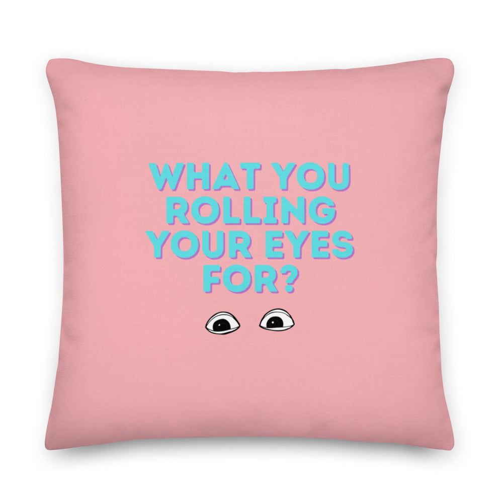 Front-facing pink square pillow reading “WHAT YOU ROLLING YOUR EYES FOR?” with cartoon eyes