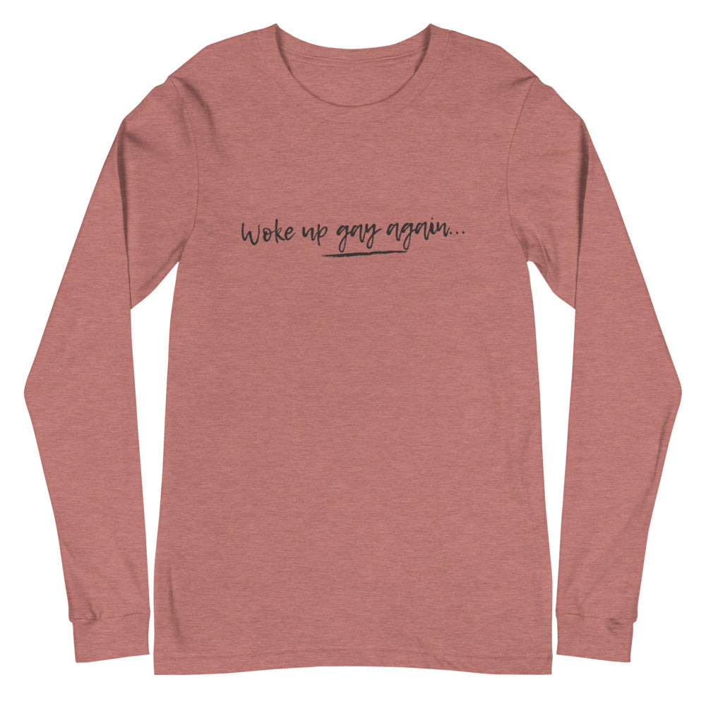 Heather mauve long-sleeve shirt reading “Woke up gay again…” in black script