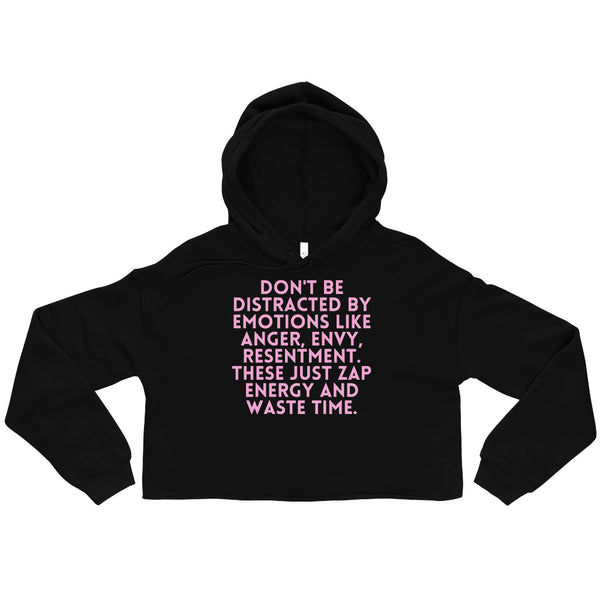 Front view of a black cropped hoodie with pink text about emotions wasting time