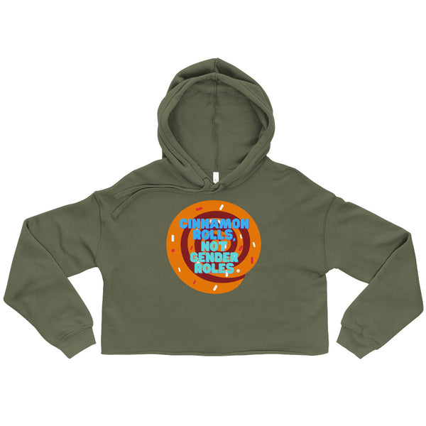 Military green cropped hoodie with a cinnamon roll graphic reading “CINNAMON ROLLS, NOT GENDER ROLES.”