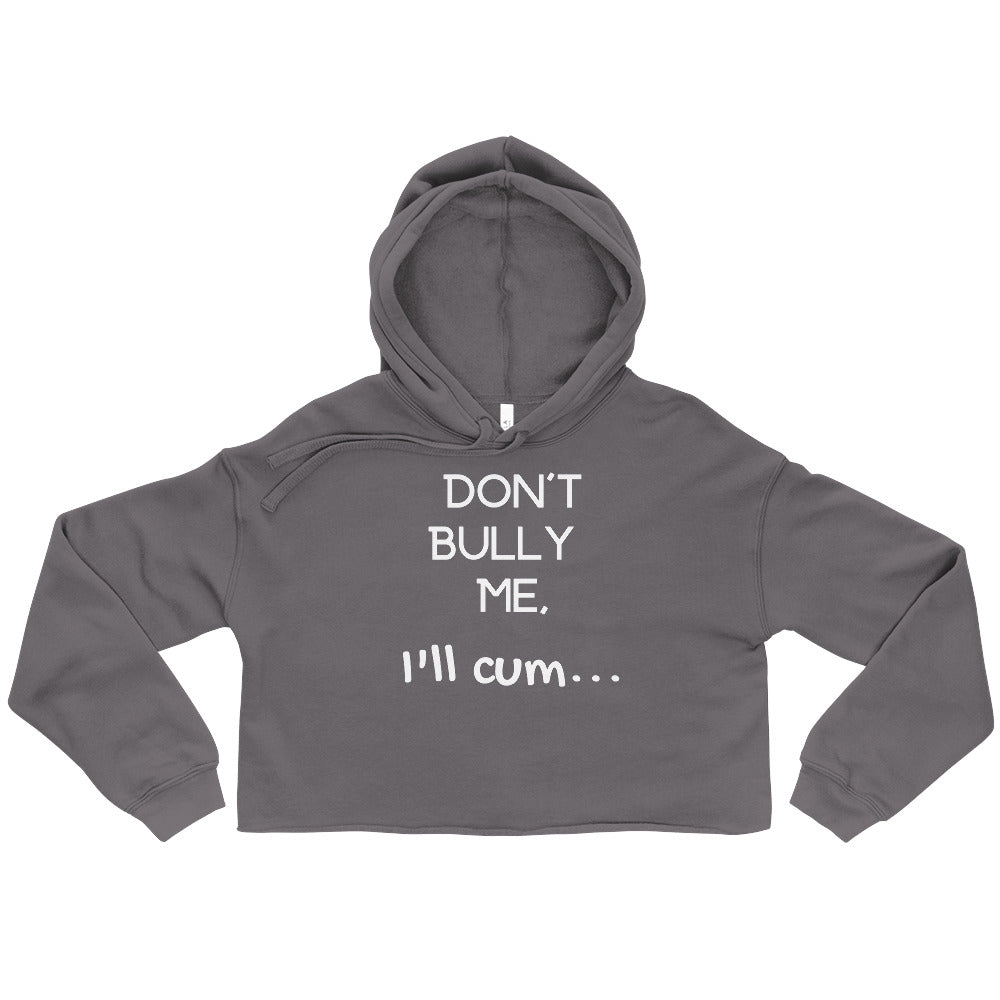 Front view of a charcoal cropped hoodie reading “DON’T BULLY ME, I’LL CUM…”