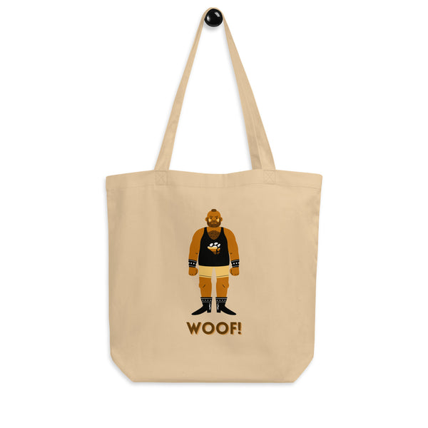 Front view of a beige tote bag showing a bearded bear in leather gear and “WOOF!” text