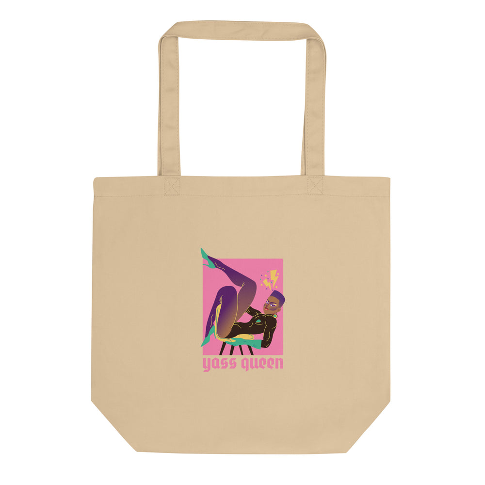 Natural beige tote bag with colorful seated figure graphic and “yass queen” text
