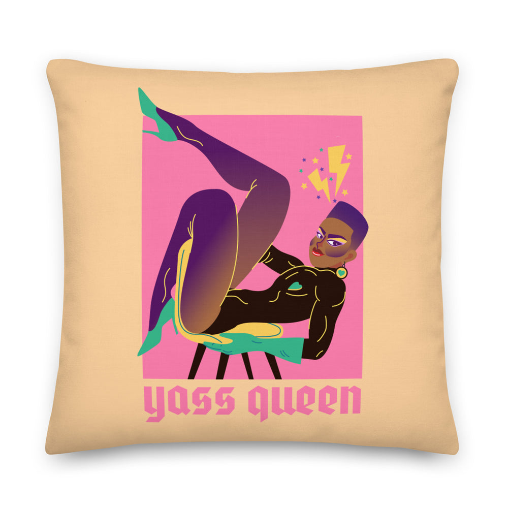 Square tan pillow with a colorful stylized reclining woman and “Yass Queen” text