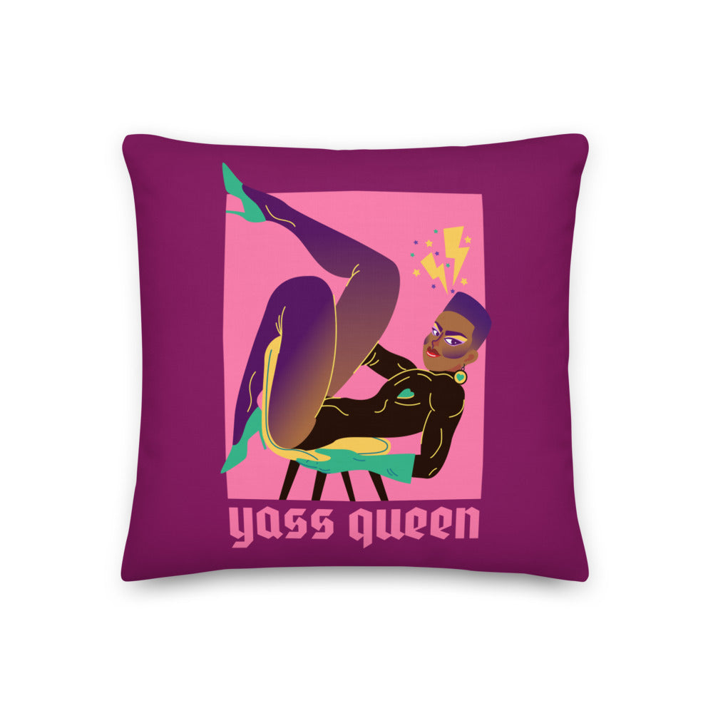 Close-up of a purple pillow featuring a drag performer illustration and “Yass Queen” text