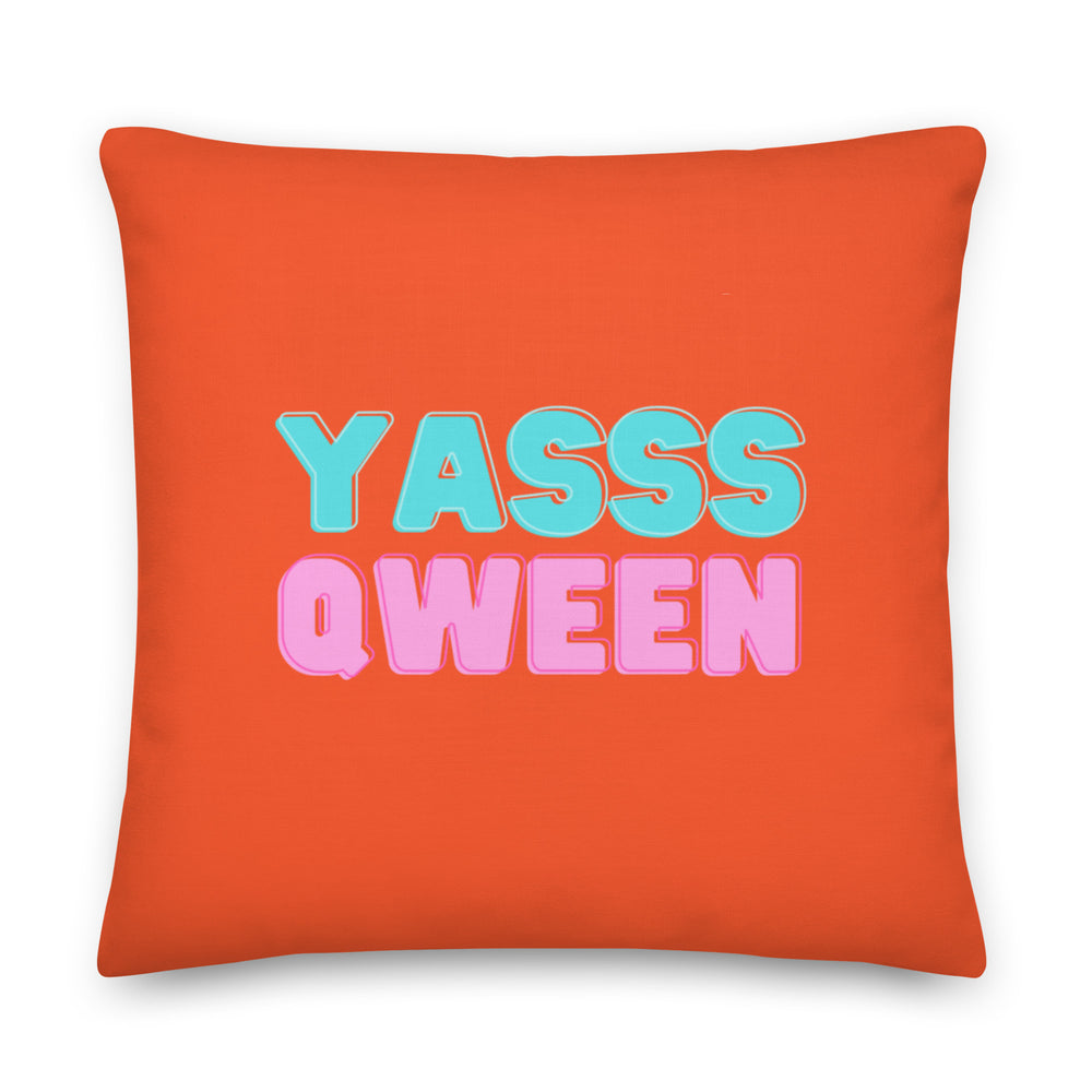 Front-facing orange square pillow with turquoise and pink “YASSS QWEEN” lettering