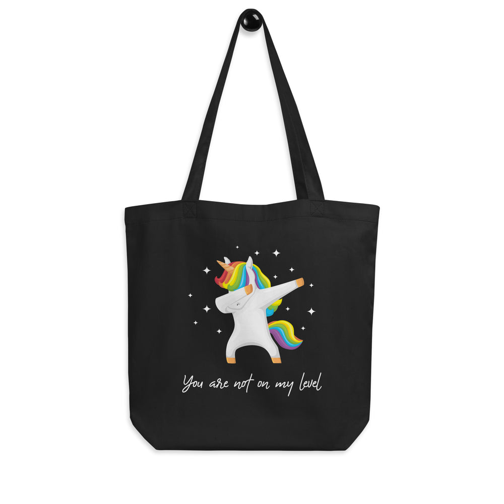 Front view of a black tote bag with a rainbow-maned unicorn and “You are not on my level” text