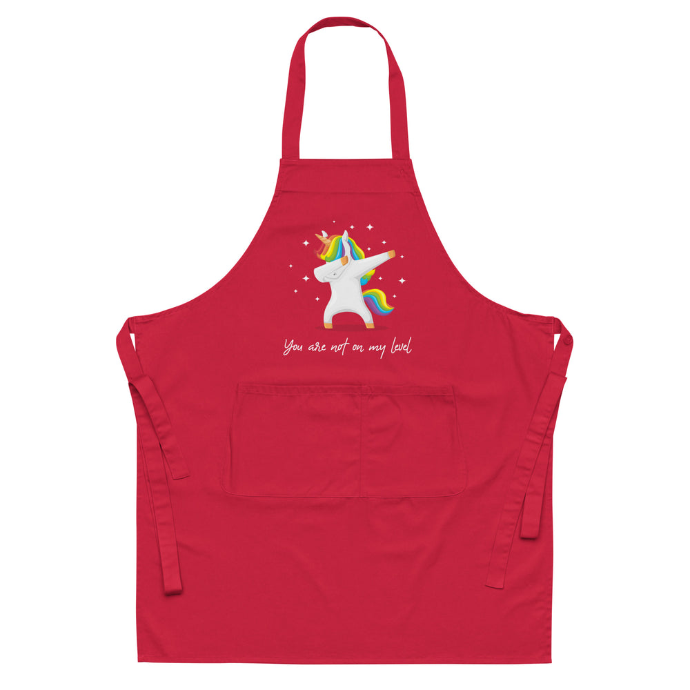 Red apron with a rainbow-maned unicorn doing a dab and the words “You are not on my level”