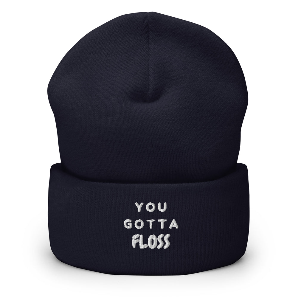 Front view of a navy cuffed beanie embroidered “YOU GOTTA FLOSS” in white
