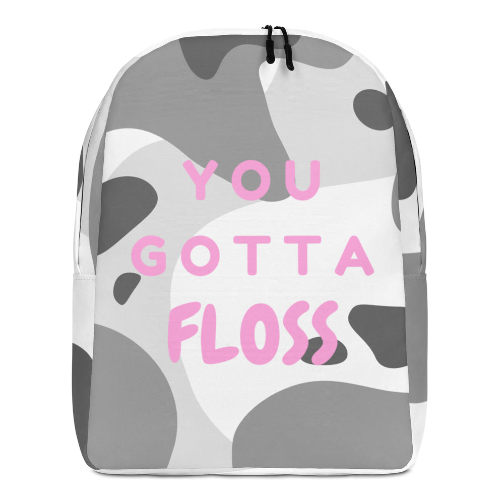 Front view of a gray-and-white backpack reading “YOU GOTTA FLOSS” in pink letters