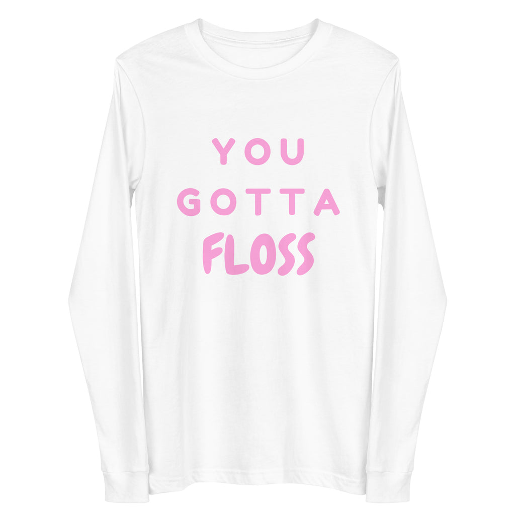 Front view of a white long-sleeve shirt reading “YOU GOTTA FLOSS” in pink letters