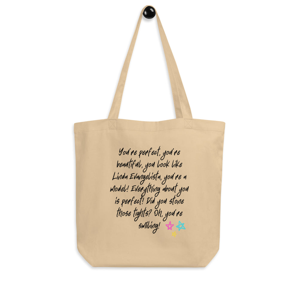 Front view of a beige tote bag with black quote text and three colorful stars