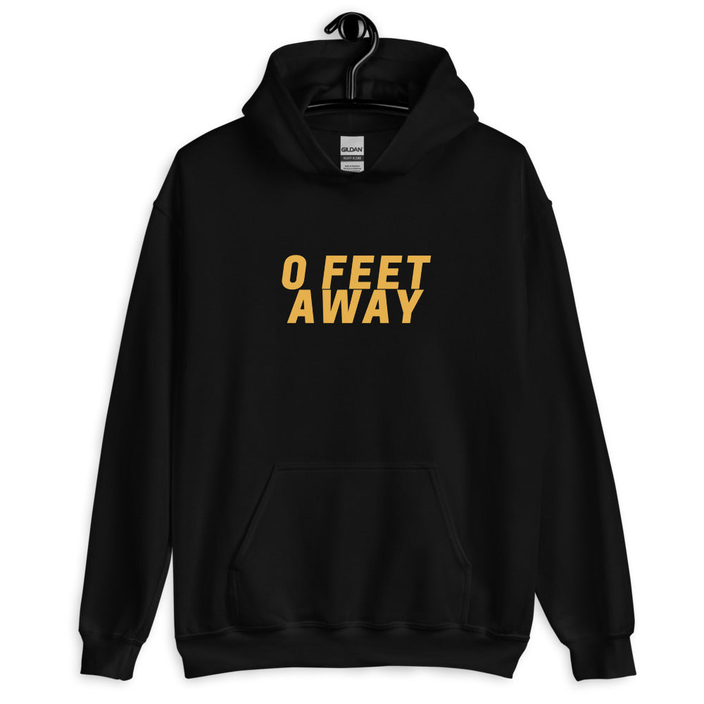 Front view of a black pullover hoodie reading “0 FEET A WAY” in yellow lettering